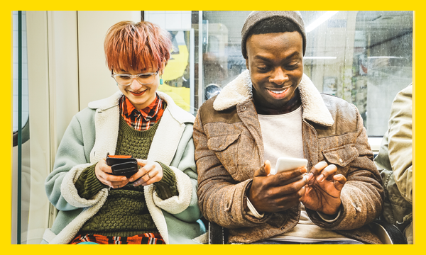 Two young people on their phones