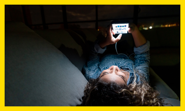 Child on phone in bed