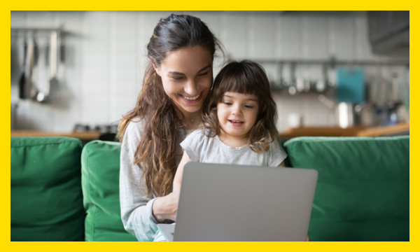 Woman and young girl looking at laptop