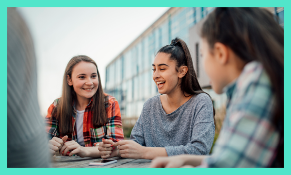 Group of young people sitting and chatting