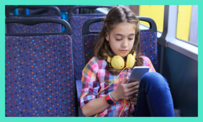 Young child on public transport using smartphone